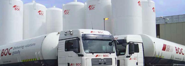 A selection of BOC bulk gas storage tanks with two BOC delivery trucks