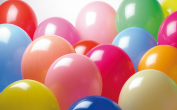 A selection of different coloured balloons filled with helium