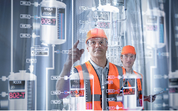 Factory supervisor monitoring product levels on interactive screen