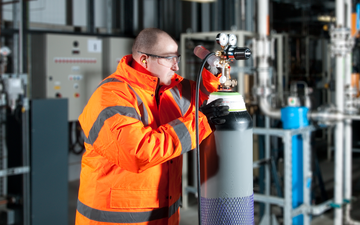An engineer inspecting a gas cylinder