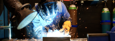 close-up of a welder wearing PPE carrying out welding